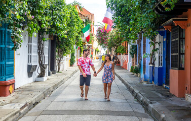 beautiful tourist couple walking in the colorful streets of cartagena de indias, colombia
