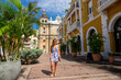 Beautiful model standing in front of the San Pedro Claver sanctuary in Cartagena de Indias, Colombia