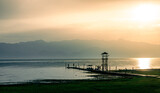 Fototapeta Fototapety pomosty - Zachód słońca na przystani nad jeziorem Szkoderskim z widokiem na góry