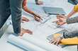 © BalanceFormCreative - Group of architect on meeting. Looking and discuss blueprint. Only hands are visible.