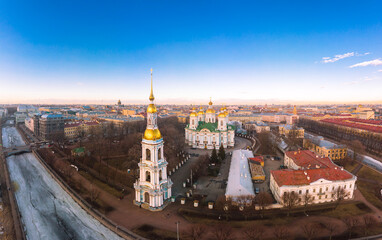 Aerial top view to St. Nicholas Naval Sea Cathedral in sunny day. Panorama of evening historical city center. Orthodox church located on banks of Kryukov and Griboyedov canal. Saint Petersburg. Russia