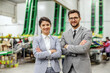 © Dusan Petkovic - Portrait of business people. A man and a woman well dressed in an elegant suit pose for a photo in a business environment in a factory. Positive attitude and smiling face, self-confidence and career
