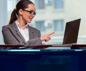 Businesswoman with laptop in business concept