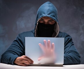 computer hacker working in dark room