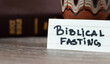 Biblical fasting concept. A close-up of handwritten text with Holy Bible Book. Faithful Christian fast, repentance, prayer before God and Jesus Christ. Spiritual relationship with the LORD.