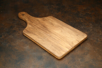 Wood cutting board for homemade bread cooking isolated on rusty background. Empty wooden tray at rusty