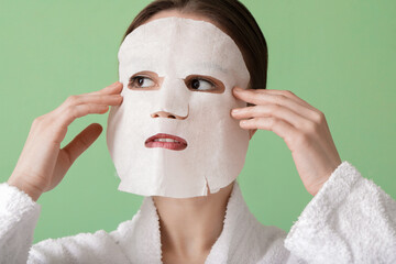 Sticker - Beautiful young woman with sheet facial mask on color background