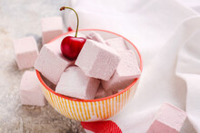 Bowl With Tasty Sweet Marshmallows And Cherry On Light Background