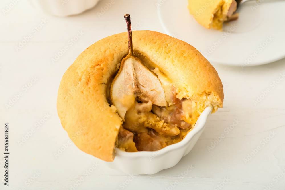 Tasty pear pot pie on light wooden background, closeup
