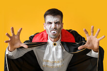 Man Dressed As Vampire For Halloween On Color Background