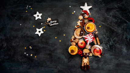 Wall Mural - Christmas tree made of food on dark background.