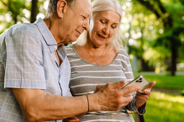 Wall Mural - Happy senior couple with smartphones