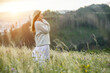 © Andrii IURLOV - Happy woman enjoying sunset stay on the green grass on the forest peak of mountain. Fresh air, Travel, Summer, Fall, Holidays, Journey, Trip, Lifestyle.