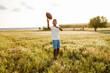 © Drobot Dean - Black boy smiling while playing with rugby ball