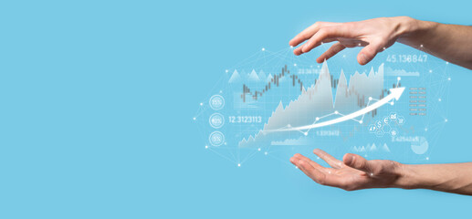 Businessman in hand hold banking business finance graph and invest in stock market investment point,economic growth and investor concept.analysis virtual stock market chart,analyze by use technology