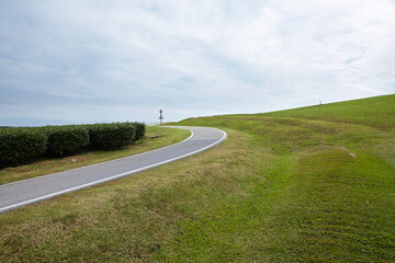 Poster - Closeup of road in sunny meadow environment outdoors