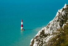 This Is A Scenic View By Day On The Blue Sea And Beachy Head Lighthouse, White Cliffs Of The Seven Sisters, East Sussex, Eastbourne, England, UK.