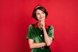 Photo of minded dreamy cheerful happy woman santa helper elf look empty space isolated on red color background