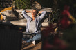 © Westend61 - Tired female professional relaxing with hands behind head on terrace