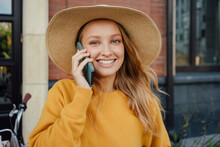 Beautiful Blond Woman Wearing Hat Talking On Smart Phone