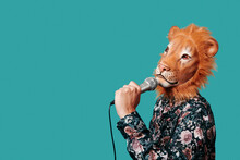 Man Wearing A Lion Mask Speaks Into A Microphone