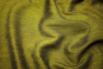Wall Mural - Close-up texture of natural green or brown fabric or cloth in same color. Fabric texture of natural cotton, silk or wool, or linen textile material. Color canvas background.