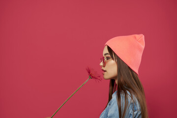 Wall Mural - woman wearing sunglasses hat posing fashion pink background