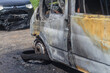 Passenger minibus after a fire, burnt body and interior of the car