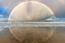 New Zealand Seascape Of Rainbow With Reflection Forming A Circle