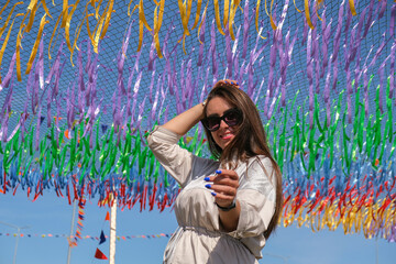 Young woman on festival. Gen z girl enjoying outdoors, expressing positive emotions having fun in park. Millennial generation lifestyle.