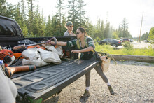 Conservation Volunteers Loading Equipment Into Pickup Truck