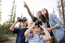 Children Looking At Wildlife Through Binoculars
