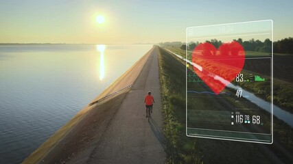 Cyclist on a tour on waterfront tracks his training development, heart rate and distance using a digital tracking device screen