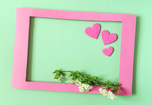 A Colored Frame Decorated With Flowers And Pink Hearts On A Light Background Of The Mine Space. Flat Ley Bright Red Paper Frame And Decor Of Flowers And Hearts