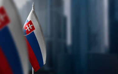 Small flags of Slovakia on a blurry background of the city