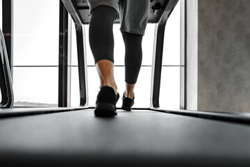 Close up of male legs running in a gym on a treadmill