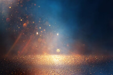 Background Of Abstract Glitter Lights. Gold, Blue And Black. De Focused