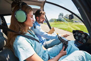 Serious concentrated young woman undergoing flight instruction