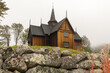 Nore Stave Church with stone fence in front. Nore, Norway