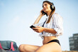 © Jelena - Happy young woman relaxing on the sandy beach. Beautiful woman listening the music