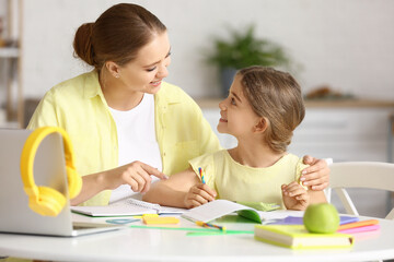 Canvas Print - Little girl with her mother doing lessons at home