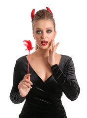 Wall Mural - Sexy young woman dressed for Halloween party on white background