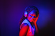 © Igor Link - Stylish fashion african american teenager model wearing headphones listening dj music dancing in purple neon lights. Young teen girl enjoy cool music