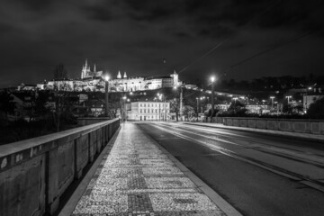 Wall Mural - Illuminated Prague Castle by night. View from Manes Bridge. Prague, Czech Republic. Black and white image.