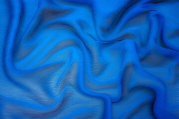 Texture, background, pattern. Texture of blue silk fabric. Beautiful blue soft silk fabric.