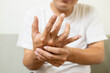 © Satjawat - Close up,asian middle-aged man with shaking of Parkinson's disease,symptom of resting tremor,male patient holding her hand to control hands tremor,neurological disorders,brain problems,health care