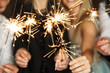 © blackday - Out of focused image of people with sparklers celebrating  holiday or event