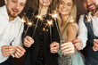 © blackday - Party people with bruning sparklers celebrating  holiday or event