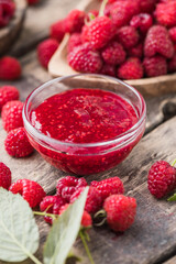 Wall Mural - Jar of raspberry jam and fresh berries with leaves. Sweet dessert