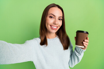 Sticker - photo of cute young brunette lady drink coffee do selfie wear blue jumper isolated on green color ba